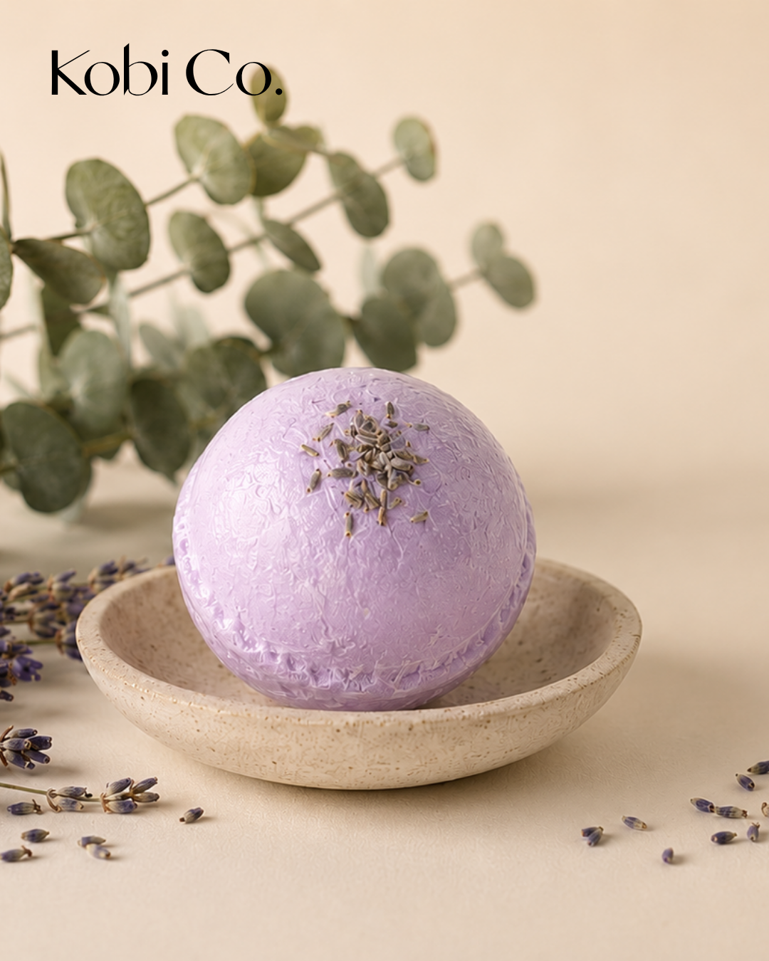 Kobi Co. #PurpleReign lavender and eucalyptus bath bomb displayed in a luxury spa-inspired setting