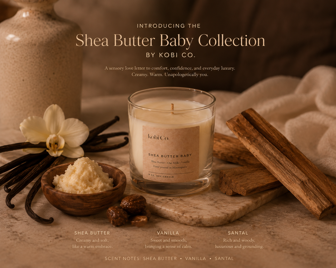 Shea Butter Baby Collection by Kobi Co. candle with vanilla beans, cinnamon sticks, and shea butter on a wooden surface.